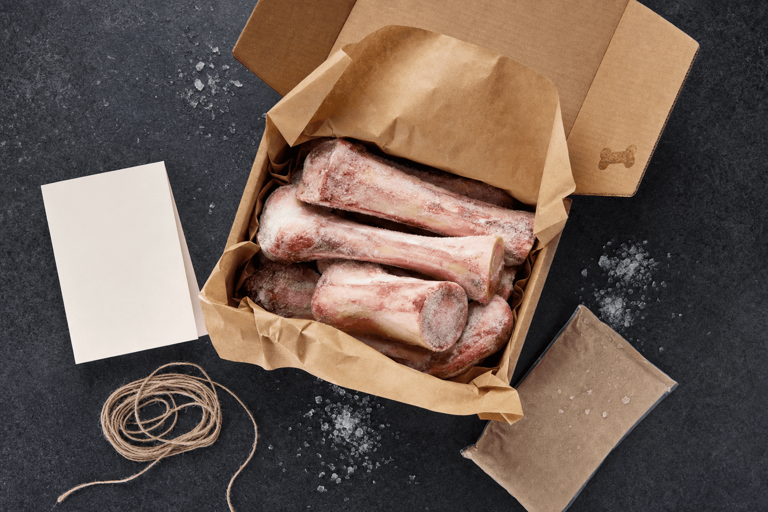 An open Six Bones box packed with raw bones